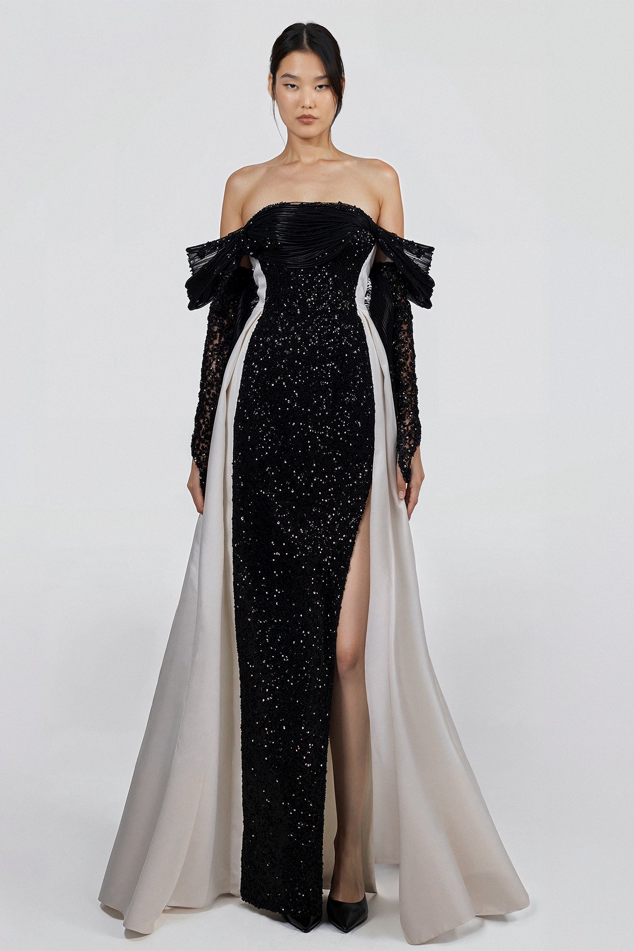 Load and play video in Gallery viewer, Black and ivory dress, off-shoulder neckline, tulle sleeves, embroidered tulle bodice with sequins, thigh slit, organza winged back, floor-length contrast cape