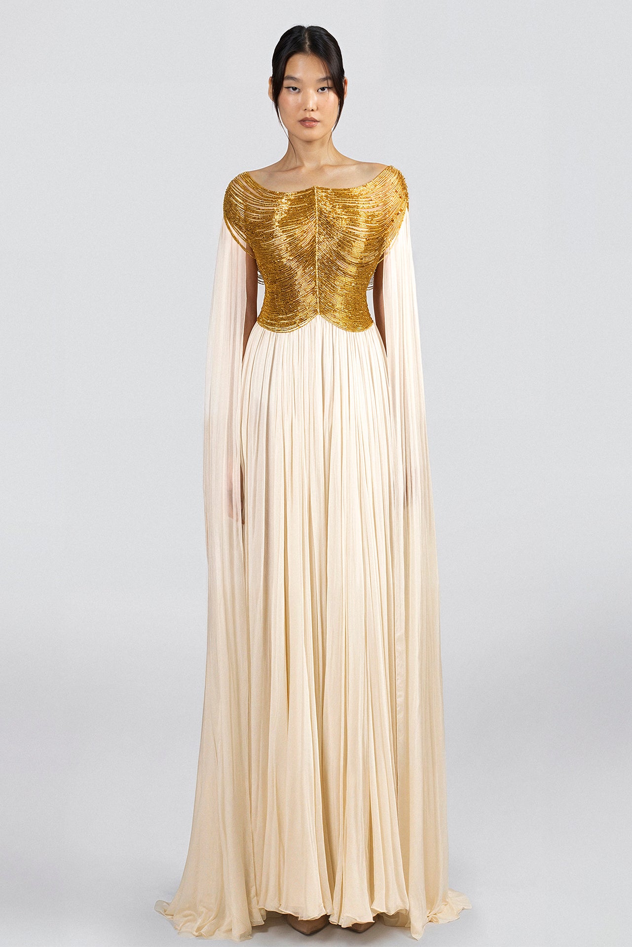 Load and play video in Gallery viewer, Fitted bodice with silene and pearls embroidery, off-shoulder neckline, floor-length silk chiffon skirt, attached cape sleeves.