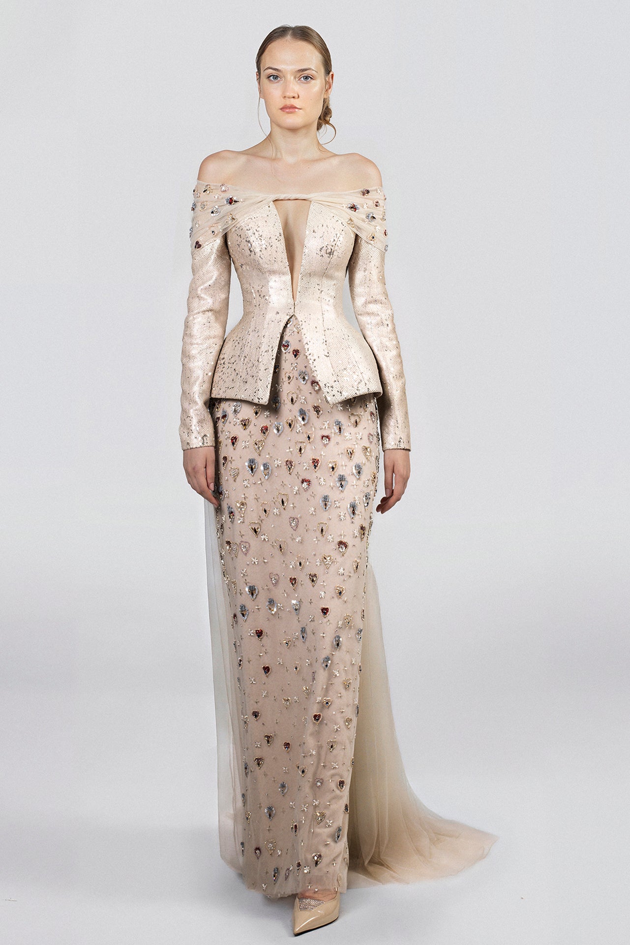 Load and play video in Gallery viewer, Greige floor-length dress, off-shoulder neckline, plunging front, sequined long sleeves, fitted bodice, peplum waist, embroidered tulle skirt, train, scattered embellishments.